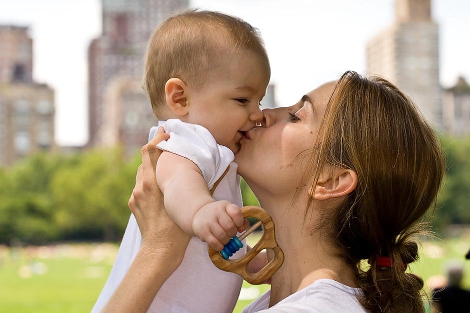 mother kissing baby