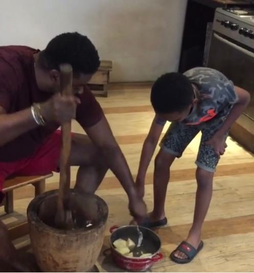 Nollywood Filmmaker, Kunle Afolayan Teaches His Son How To Pound Yam (Video)