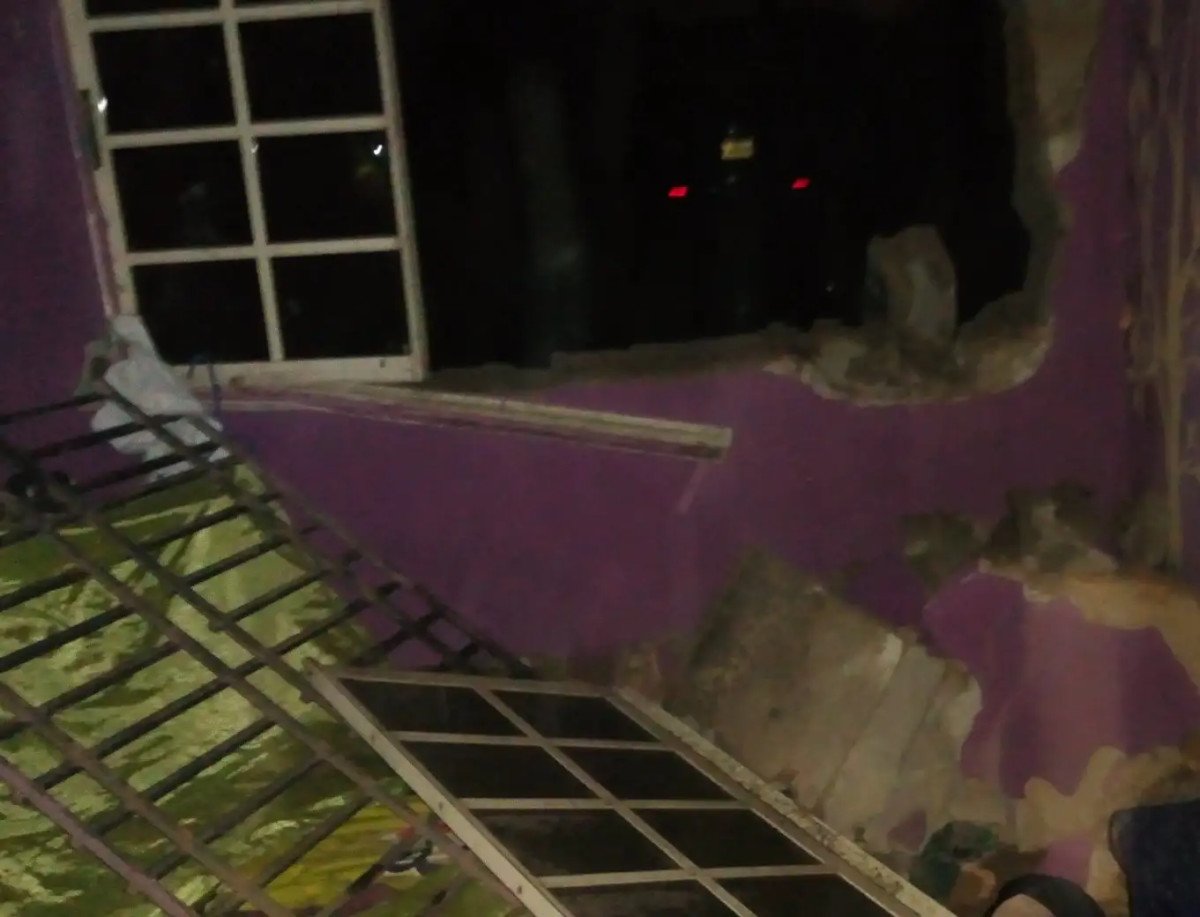 Woman escapes unharmed after heavy wind blew off her windows and wall at night