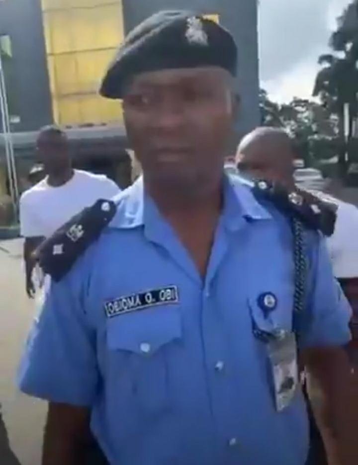 Nigerian Police Officer Assualt Peaceful Protestors With Loaded Weapon